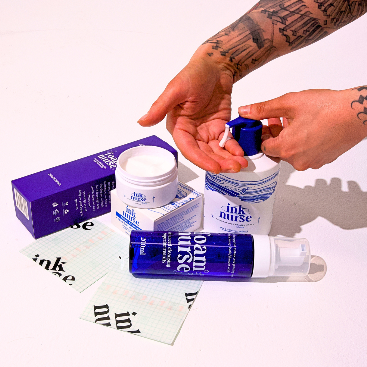 Ink Nurse Tattoo Aftercare Mega Bundle Kit: Remedy Cream, Foam Nurse wash and Tattoo Wrap Pro film, applied to a tattooed arm.